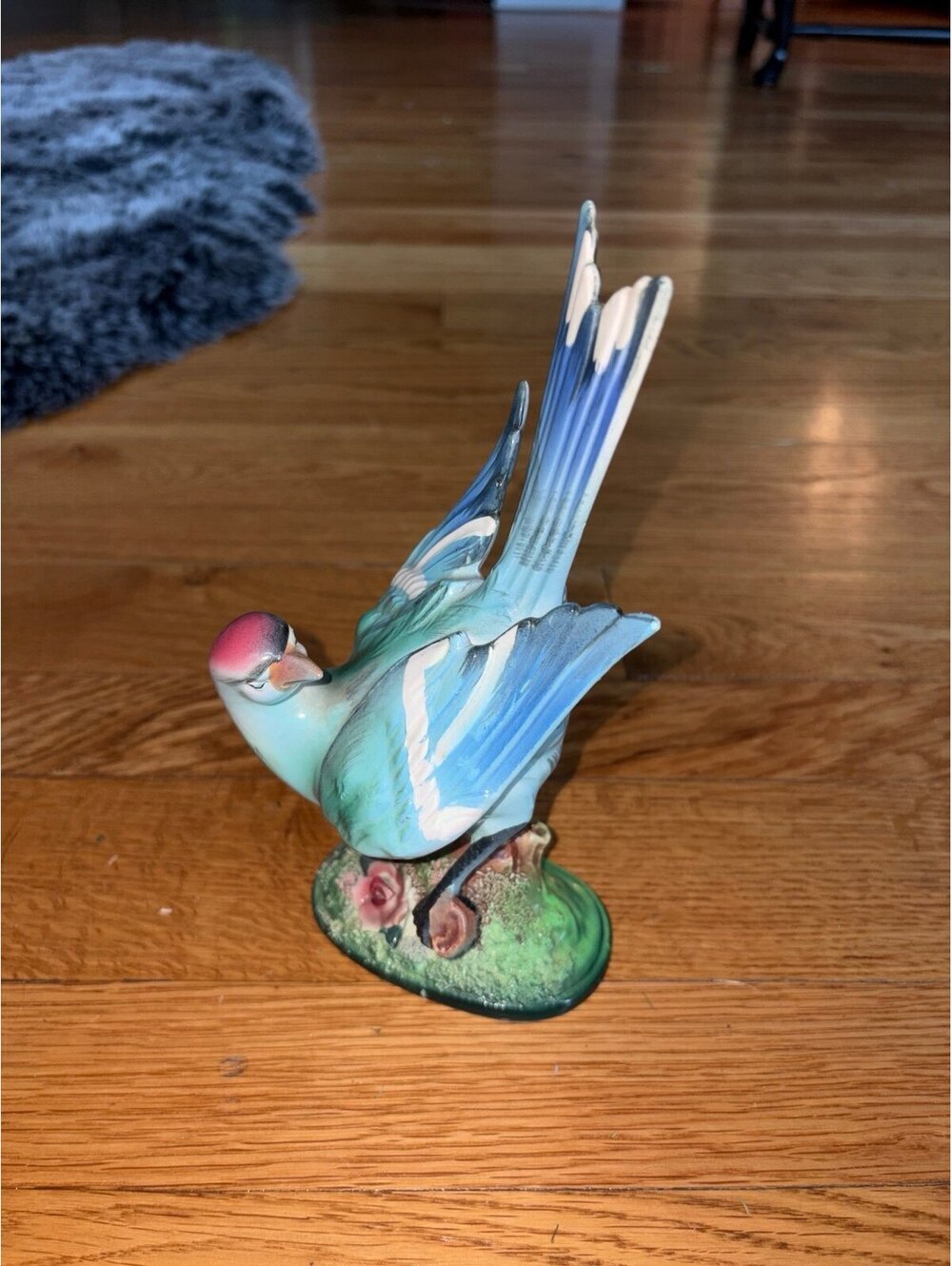 vintage mid-century hand-painted ceramic blue bird figurine on a textured green